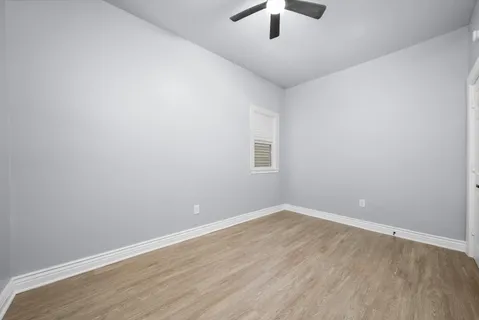 an empty room with a empty space and chandelier fan