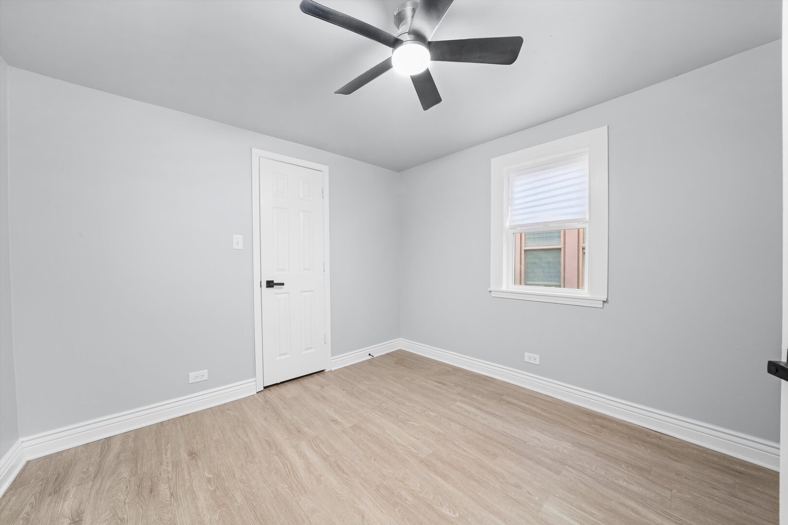 7917 South Ellis Avenue Chicago, IL 60619 - Photo 24 of 33 an empty room with ceiling fan and windows