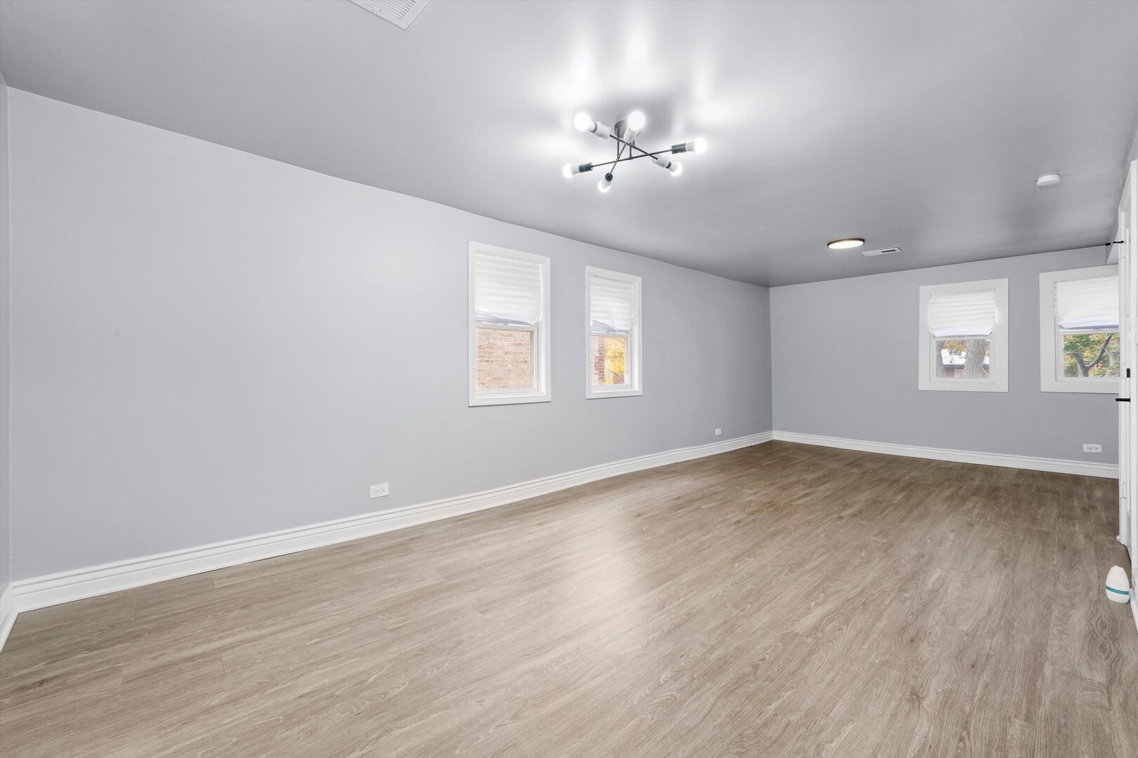 7917 South Ellis Avenue Chicago, IL 60619 - Photo 26 of 33 a view of an empty room with wooden floor and a window