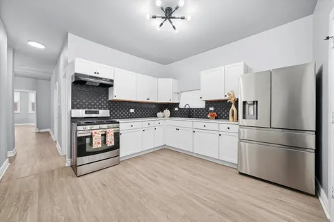 a kitchen with stainless steel appliances a refrigerator sink and cabinets