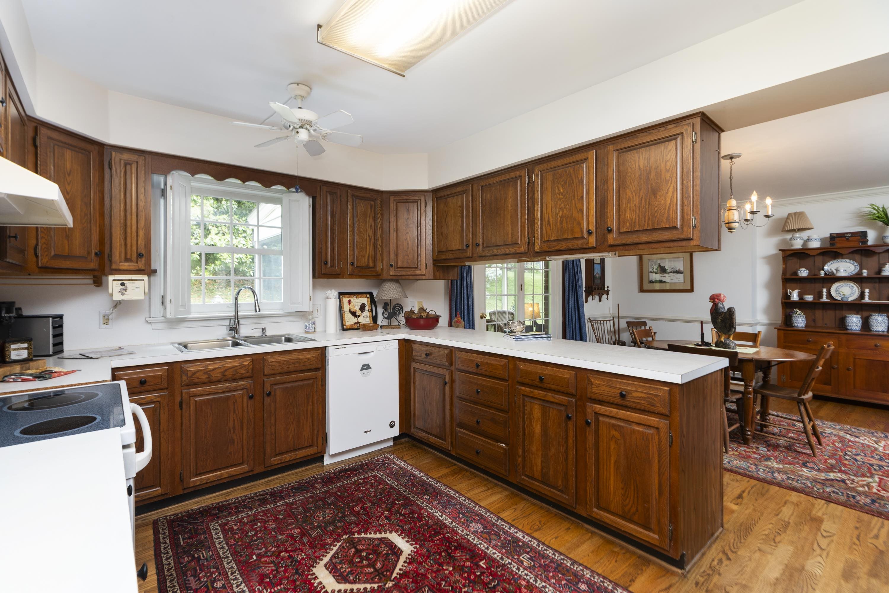 1430 Dogwood Road Staunton, VA 24401 - Photo 26 of 68 a kitchen with stainless steel appliances granite countertop a stove top oven a sink dishwasher and cabinets with wooden floor