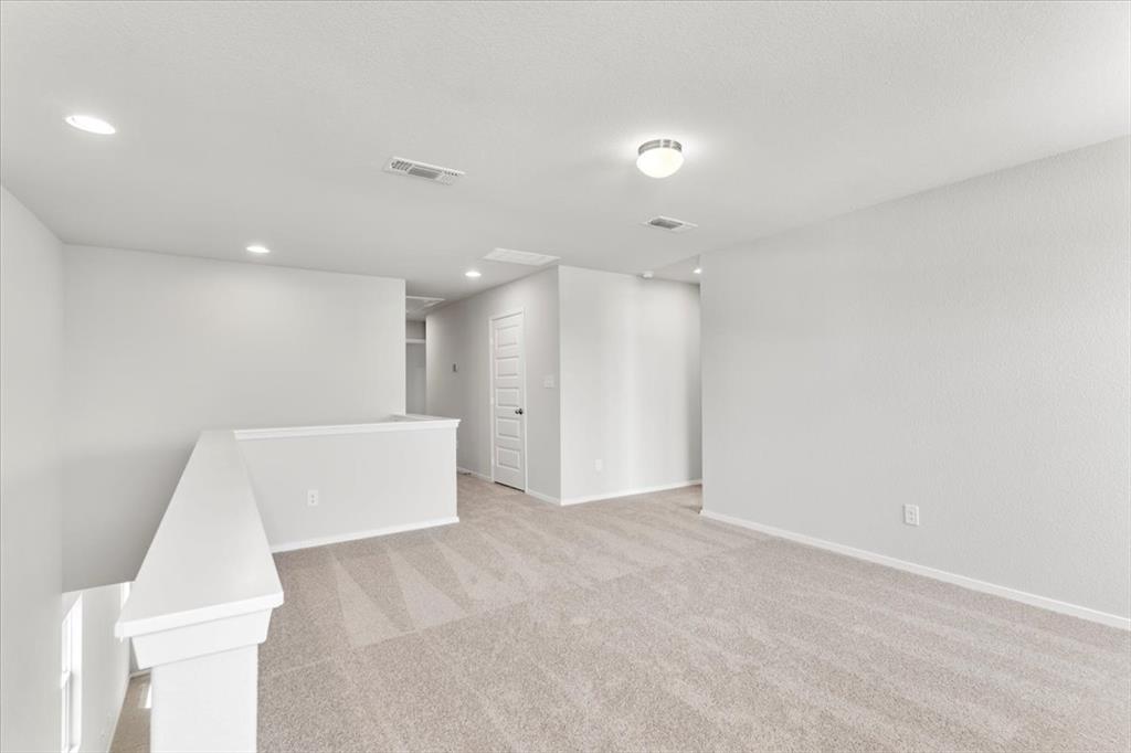 2707 Totley Road Manor, TX 78653 - Photo 22 of 39 Unfurnished room featuring light colored carpet and recessed lighting