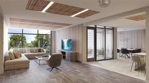 a living room with furniture and large windows