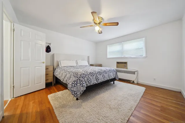 a bedroom with a bed and ceiling fan