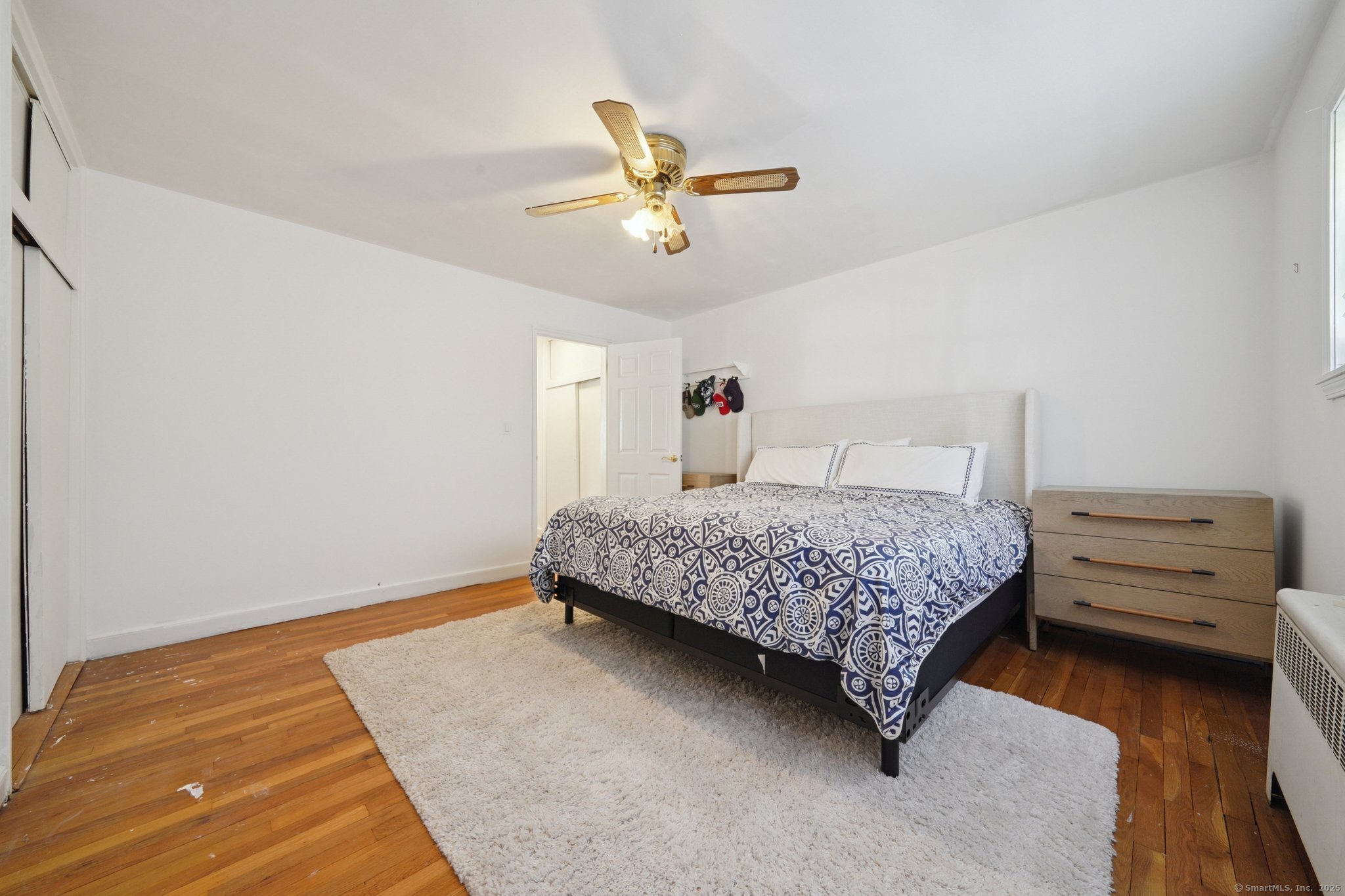 108 Strawberry Hill Avenue, Unit 1 Stamford, CT 06902 - Photo 14 of 20 a bedroom with a bed and ceiling fan