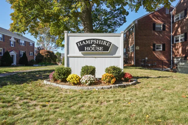 a view of a brick building next to a yard