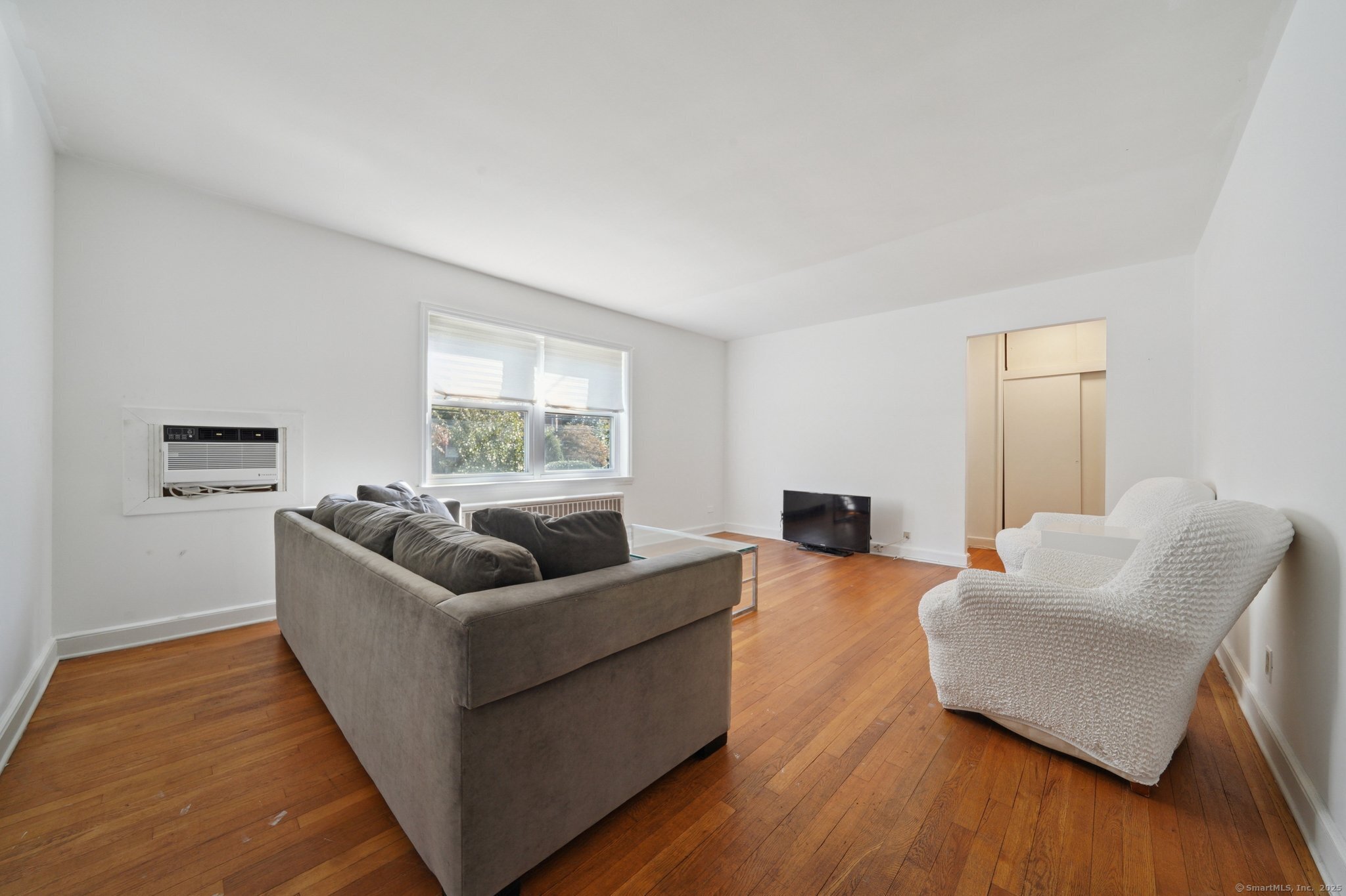 108 Strawberry Hill Avenue, Unit 1 Stamford, CT 06902 - Photo 4 of 20 a living room with furniture and a large window