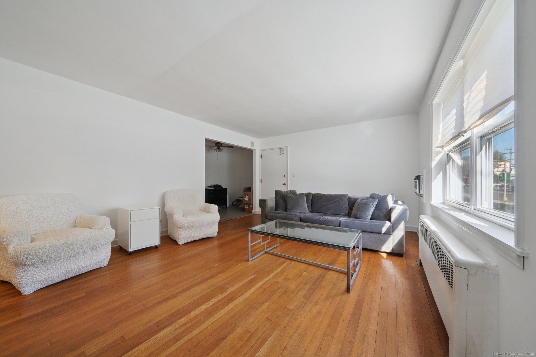 108 Strawberry Hill Avenue, Unit 1 Stamford, CT 06902 - Photo 7 of 20 a living room with furniture and a wooden floor