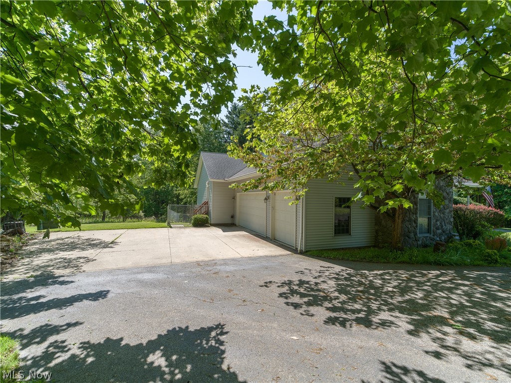 8745 Broadview Road Broadview Heights, OH 44147 - Photo 40 of 49 Spacious driveway with ample parking, a two-car garage with white doors, and a stone facade section