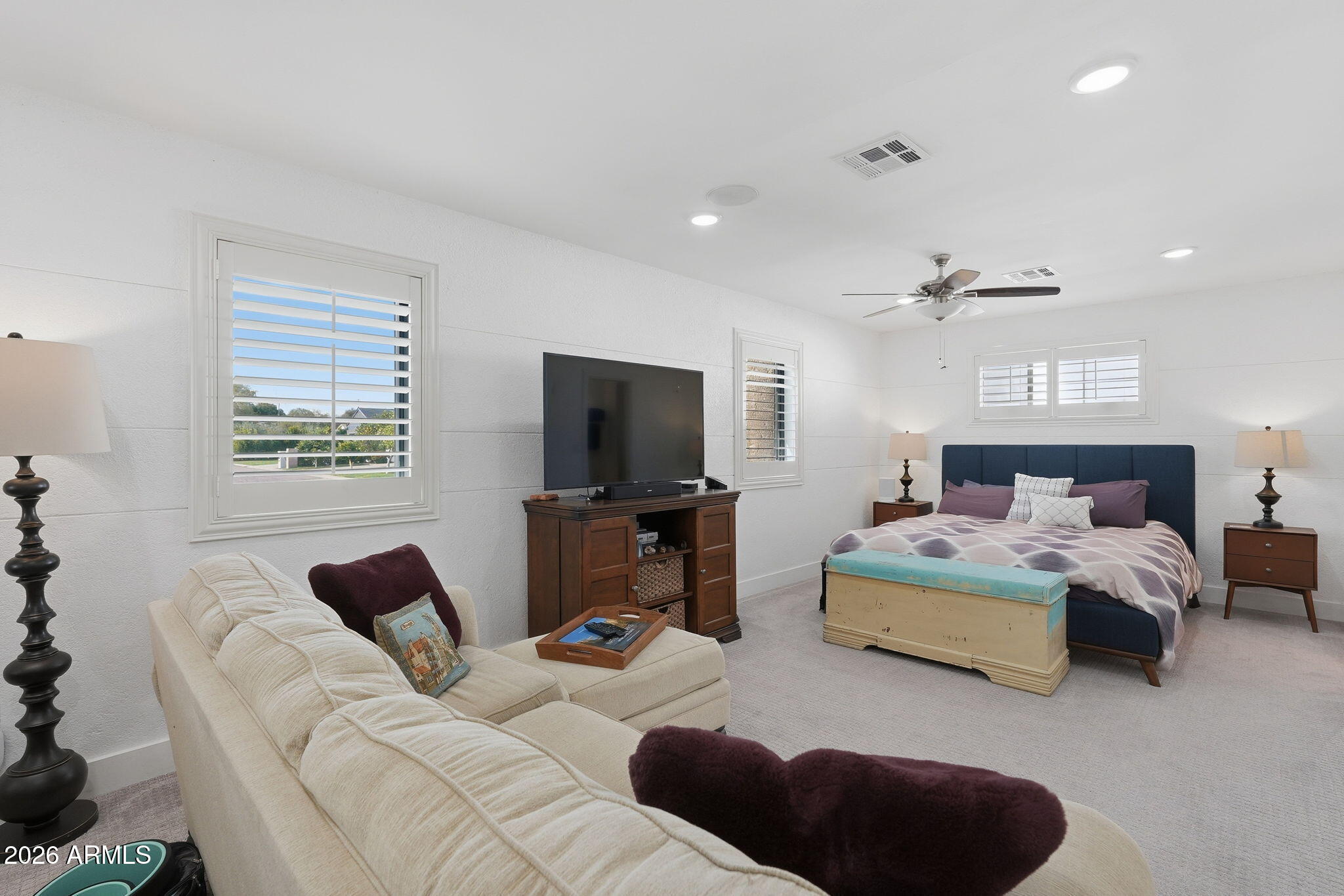 5149 North 34th Street Phoenix, AZ 85018 - Photo 37 of 70 a bedroom with a bed a couch and a flat screen tv