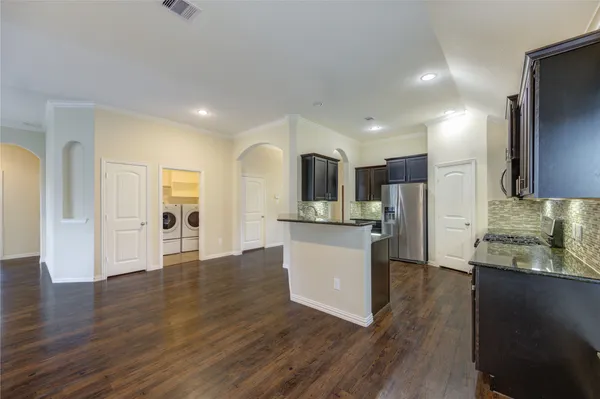 a kitchen with stainless steel appliances granite countertop a stove and a sink