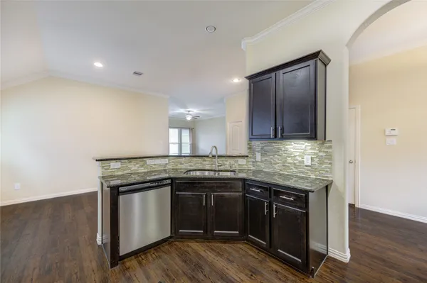 a kitchen with granite countertop stainless steel appliances and wooden cabinets