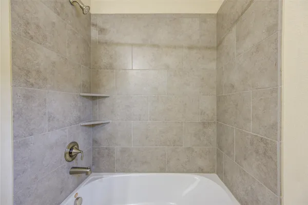 a bathroom with a tub and shower