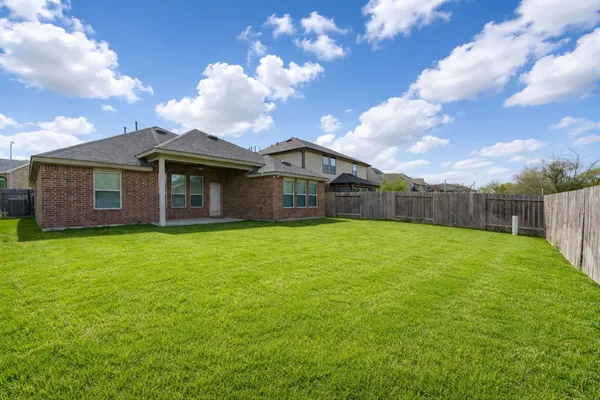 a view of a backyard with brick wall