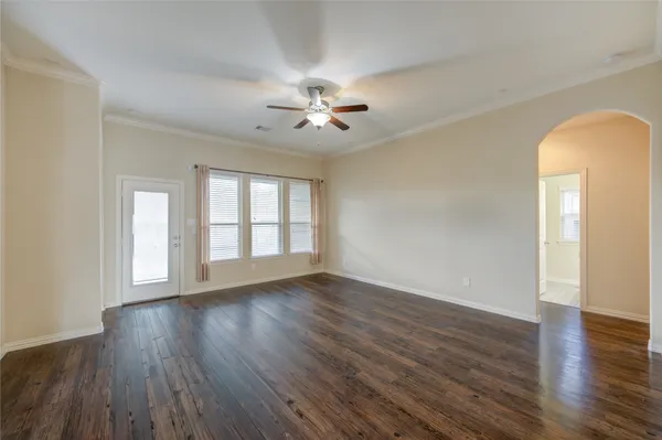 a view of a big room with wooden floor and windows