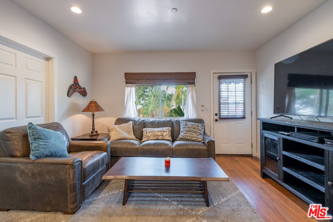 6820 Parsons Trail Tujunga, CA 91042 - Photo 13 of 36 a living room with furniture a flat screen tv and a window