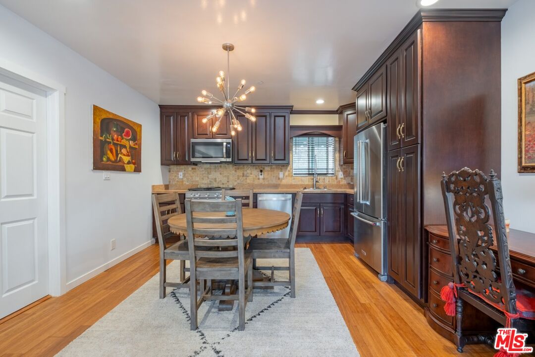 6820 Parsons Trail Tujunga, CA 91042 - Photo 14 of 36 a kitchen with stainless steel appliances kitchen island granite countertop a refrigerator and a stove