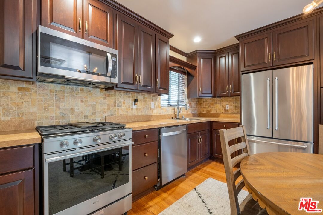 6820 Parsons Trail Tujunga, CA 91042 - Photo 15 of 36 a kitchen with stainless steel appliances granite countertop a stove microwave and refrigerator
