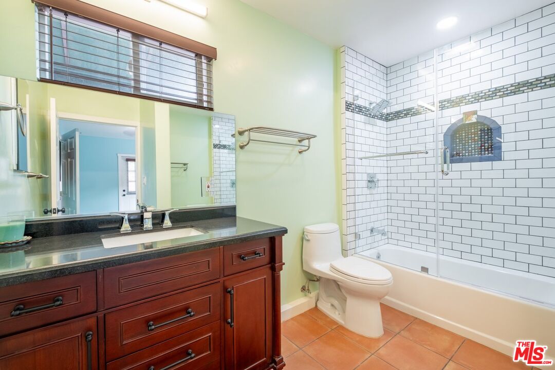 6820 Parsons Trail Tujunga, CA 91042 - Photo 20 of 36 a bathroom with a granite countertop toilet a sink and a bathtub