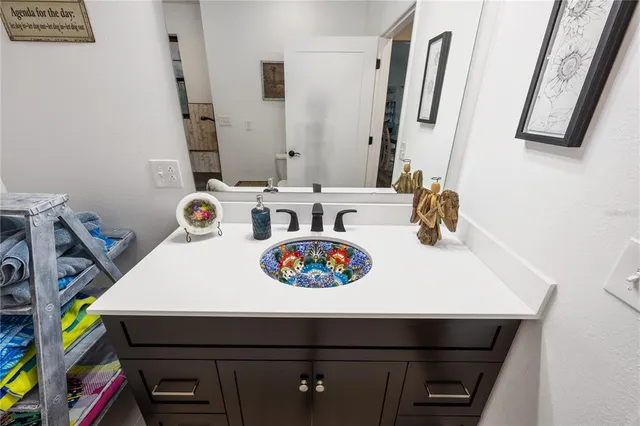 a spacious bathroom with a double vanity sink and mirror