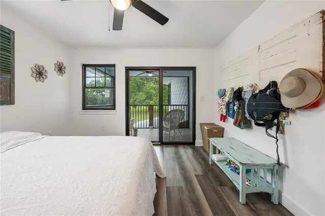 a view of a green field with trees in the background
