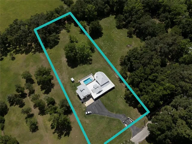 a large white kitchen with lots of counter space and wooden floor