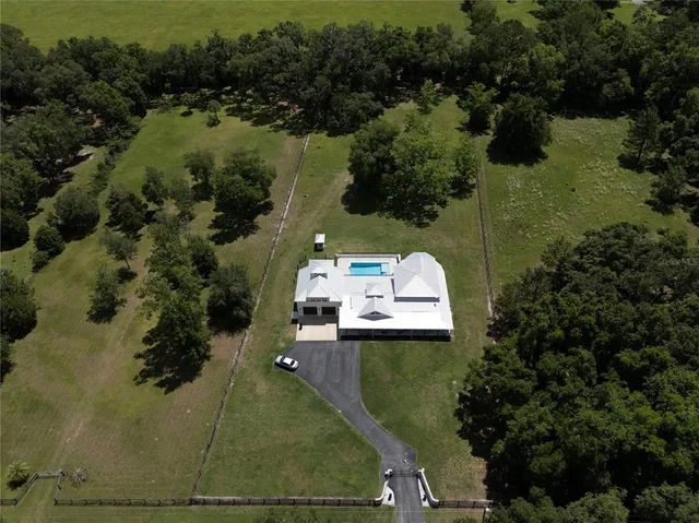 a kitchen with granite countertop white cabinets stainless steel appliances and sink