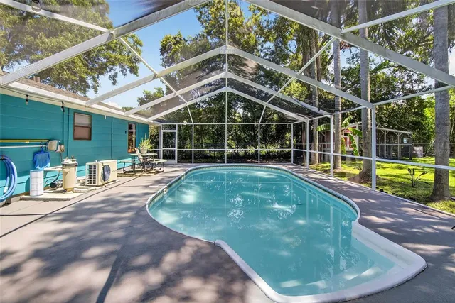 a view of a backyard with a small deck and wooden floor