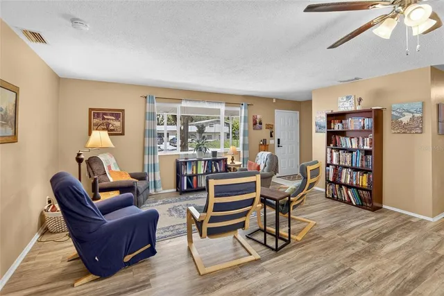 a living room with furniture and wooden floor