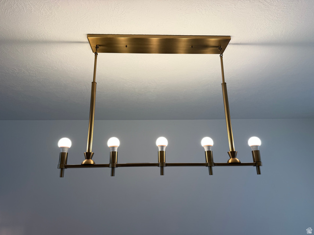 774 West 480 South American Fork, UT 84003 - Photo 22 of 76 Linear chandelier with six exposed bulbs, featuring a brass finish and a rectangular ceiling mount