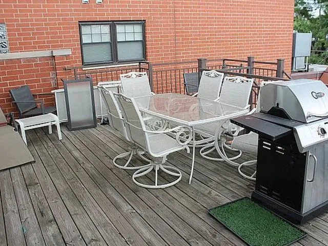 a view of a patio with table and chairs