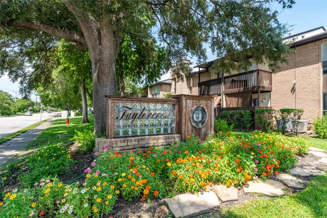 a sign that is in front of flowers