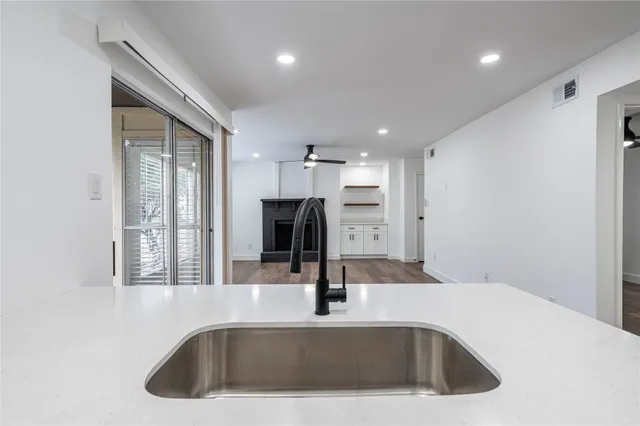 a kitchen with a sink a counter top space and stainless steel appliances