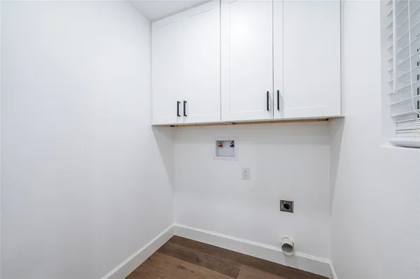 a view of a closet with wooden floor