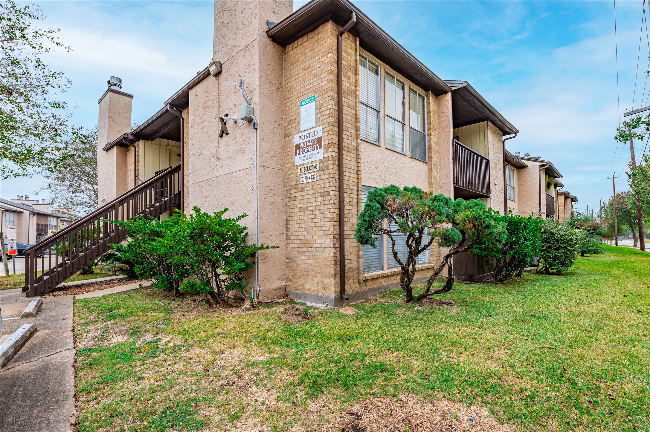 1500 Bay Area Boulevard, Unit 331 Houston, TX 77058 - Photo 3 of 27 a view of a house with brick walls and a yard with plants