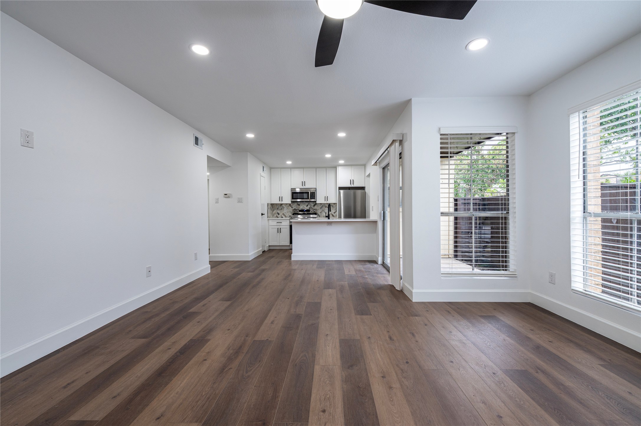 1500 Bay Area Boulevard, Unit 331 Houston, TX 77058 - Photo 8 of 27 a view of a kitchen with a fridge and wooden floor
