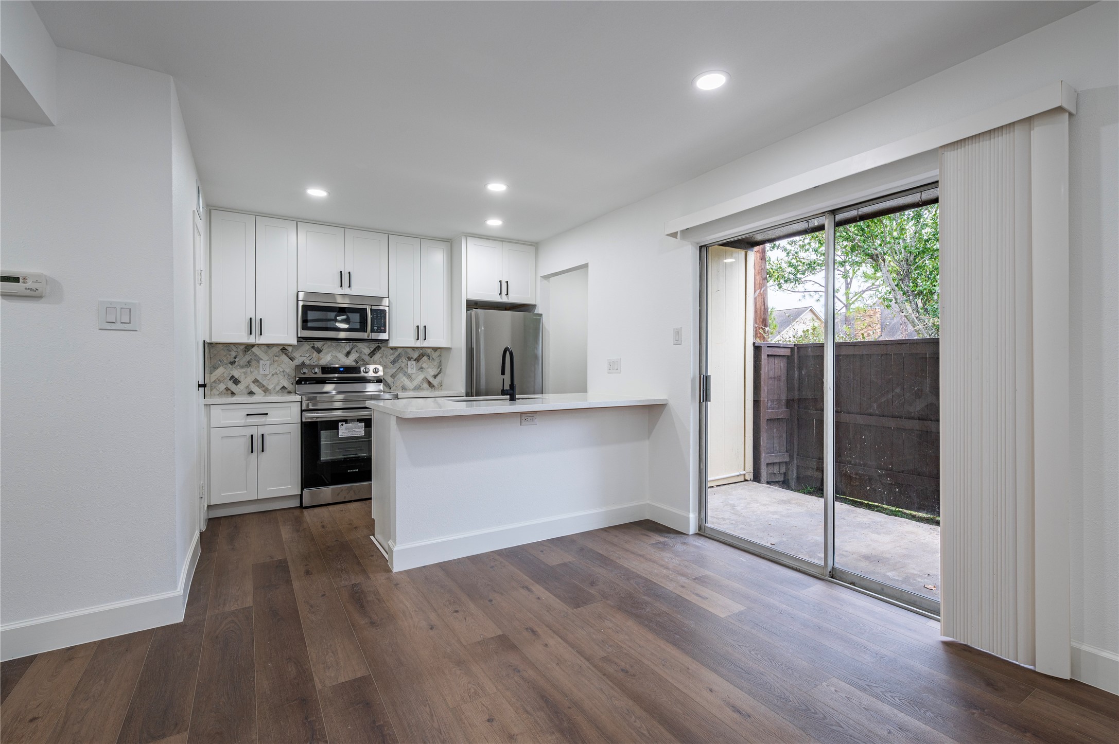 1500 Bay Area Boulevard, Unit 331 Houston, TX 77058 - Photo 9 of 27 a kitchen with kitchen island wooden floors appliances and cabinets