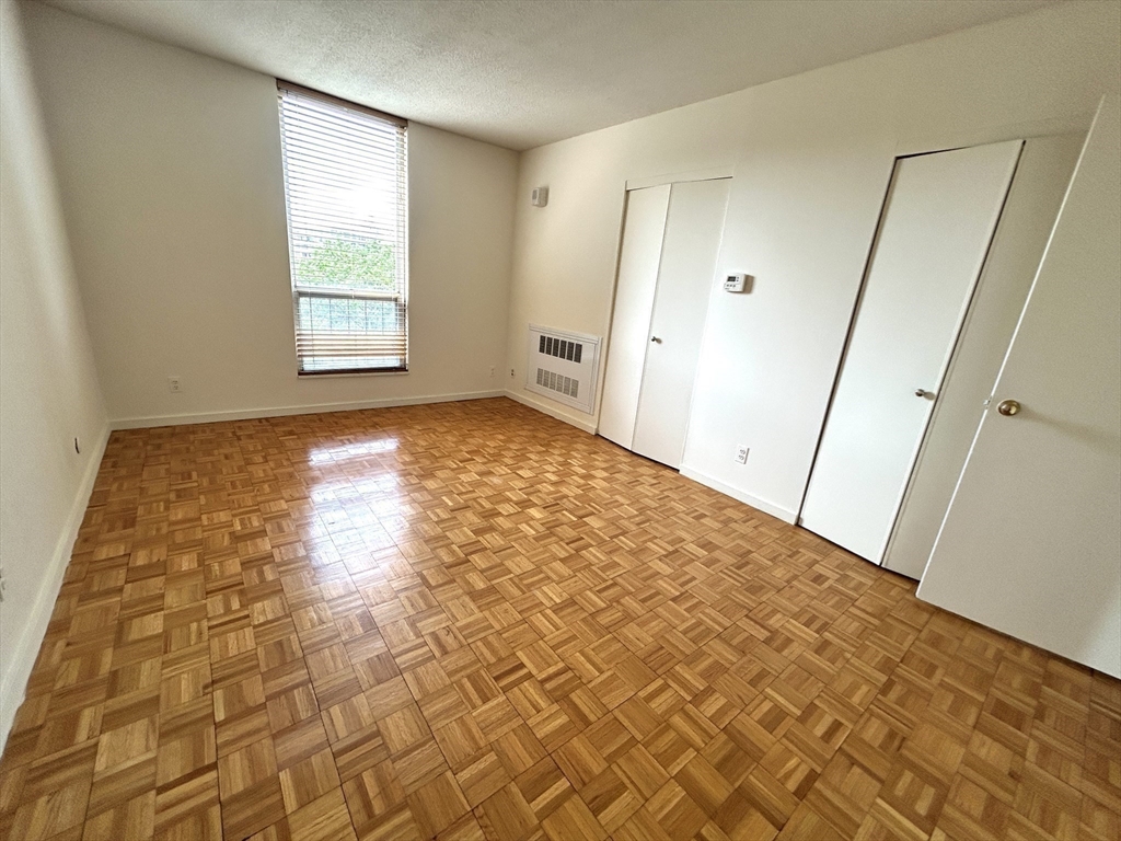 33 Pond Avenue, Unit 401 Brookline, MA 02445 - Photo 5 of 16 a view of an empty room and window