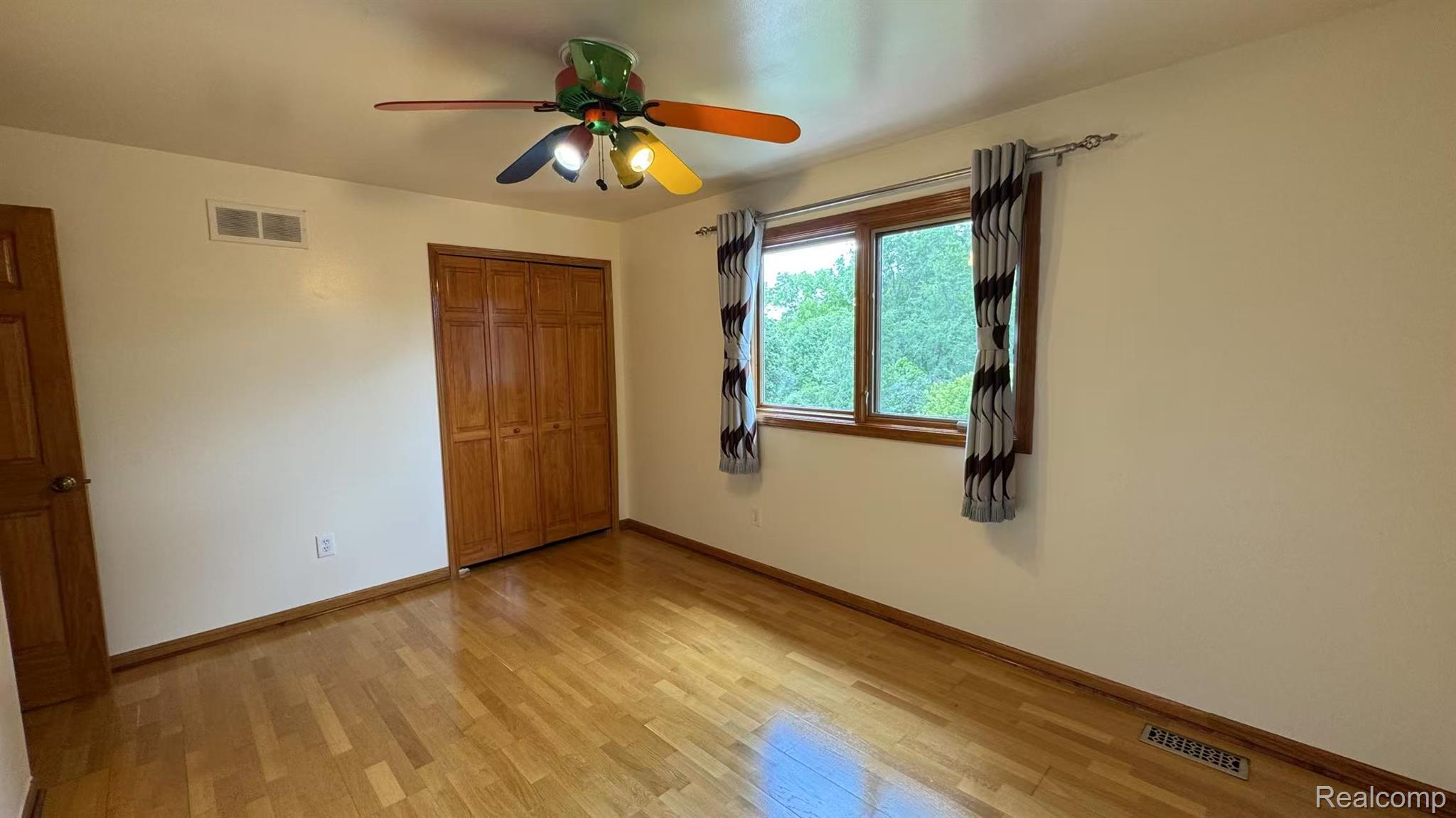 3440 Salem Drive Rochester, MI 48306 - Photo 26 of 33 Room featuring wood-finish flooring, light-toned walls, and a ceiling fan