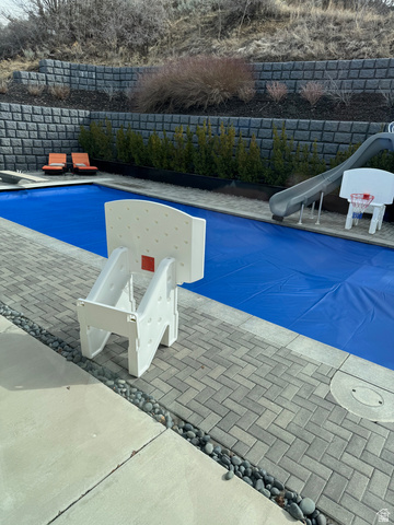 614 East High Lane Alpine, UT 84004 - Photo 13 of 75 View of pool with a water slide, a fenced backyard, a diving board, and patio surround