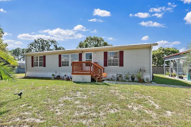 a backyard of a house with table and chairs