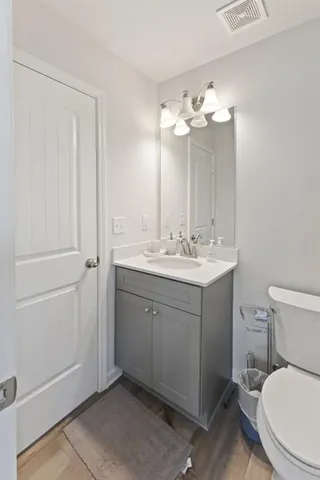 a bathroom with a toilet sink and mirror