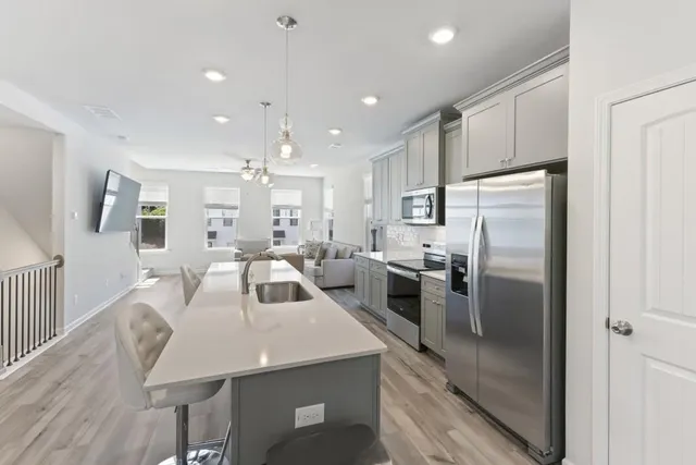 a kitchen with sink refrigerator and microwave