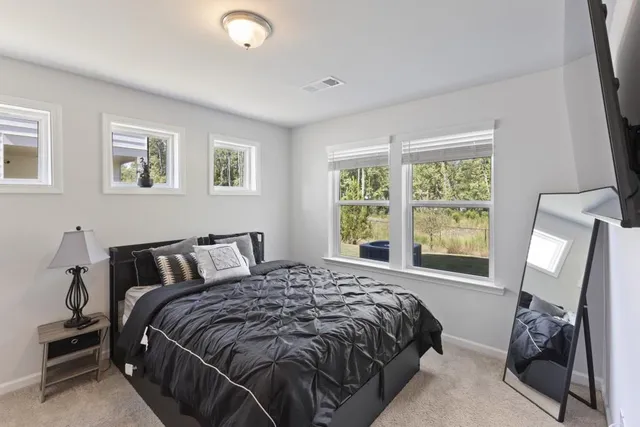 a bedroom with a bed and window