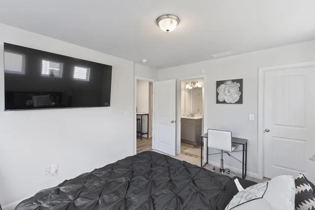 a bedroom with a bed and a television