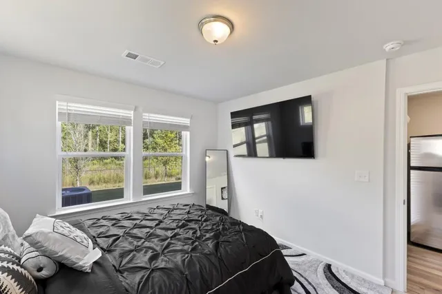 a bedroom with a bed and a window