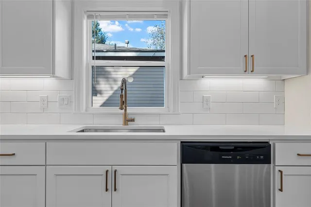 a kitchen with a sink stove and microwave