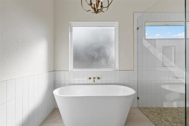 a white bath tub sitting next to a shower