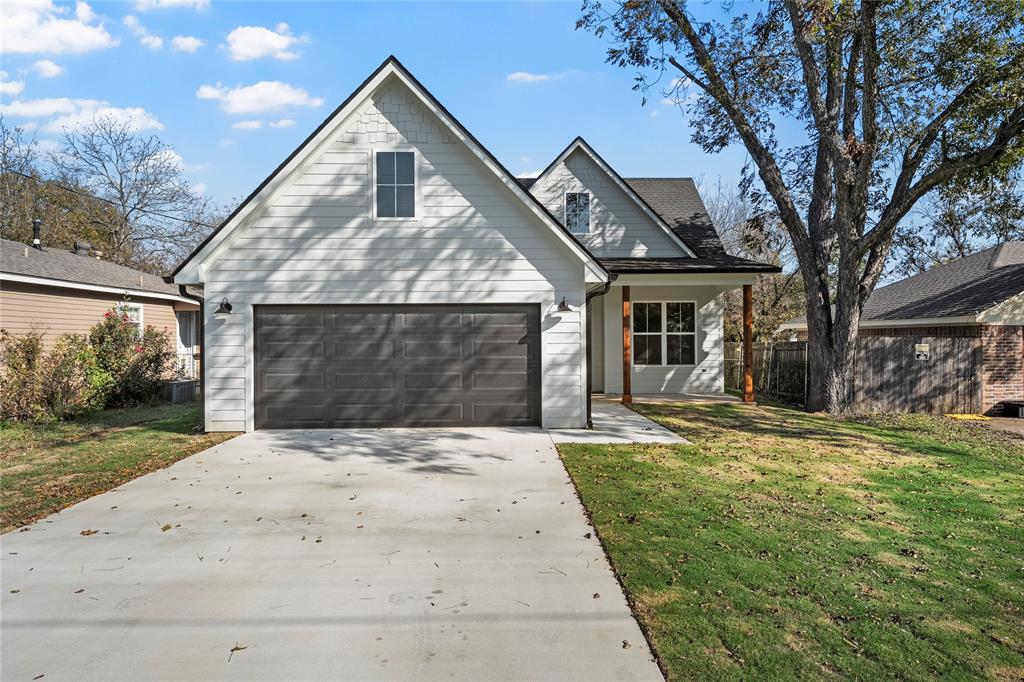 603 South Harrison Street West, TX 76691 - Photo 2 of 30 a front view of a house with a garden and trees