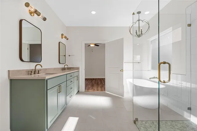 a bathroom with a double vanity sink mirror and toilet